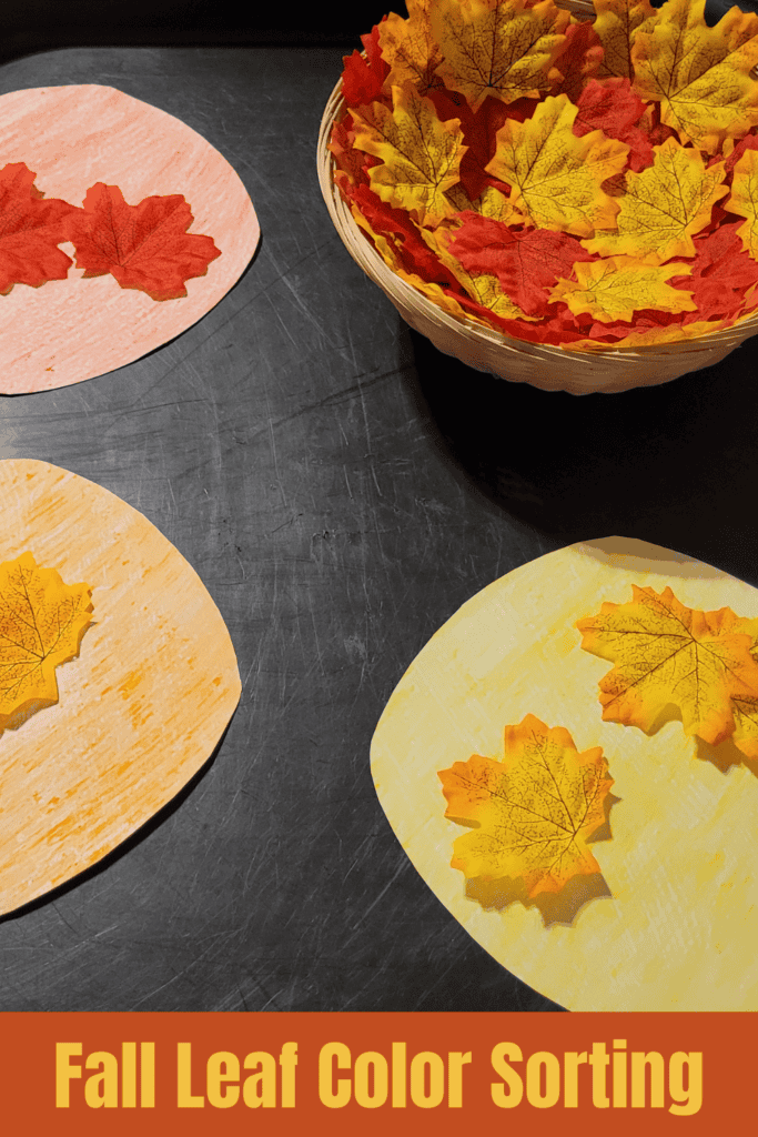 Pin text reads, fall leaf color sorting and shows an image of a basket of fall leaves and three colored circles in yellow, red, and orange for the leaves to be sorted into.